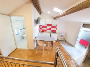 a kitchen with a table and a dining room at APPARTEMENT AGATHOIS-3 in Agde +17 photos