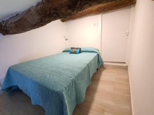a bedroom with a bed with a blue blanket at APPARTEMENT AGATHOIS-3 in Agde