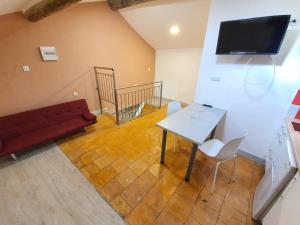 a living room with a red couch and a table at APPARTEMENT AGATHOIS-3 in Agde