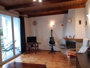 a living room with a fireplace and a television at EKO - Domek jezioro Steszewko in Stęszewko