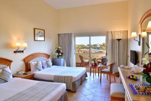 a hotel room with two beds and a balcony at Sharm Grand Plaza Resort - Families and Couples Only in Sharm El Sheikh