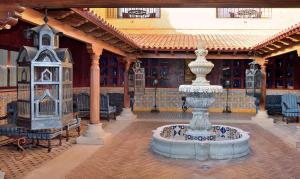 a courtyard with a fountain in the middle of a building at Europe Villa Cortes GL in Playa de las Americas