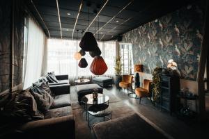 a living room with a couch and a table at Hotell Östersund in Östersund +59 photos