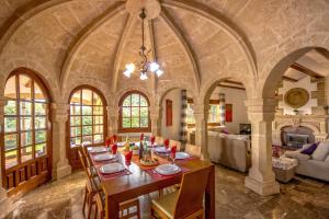 a dining room with a table in a large room at 0327 Villa El Cau in Jávea