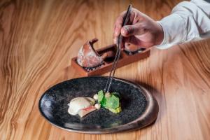 a person eating a plate of food with a fork and knife at Europe Villa Cortes GL in Playa de las Americas