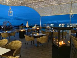 a restaurant with tables and chairs on a roof at night at Europe Villa Cortes GL in Playa de las Americas