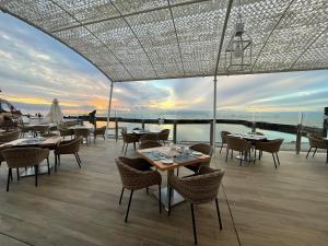 a restaurant with tables and chairs on a deck at Europe Villa Cortes GL in Playa de las Americas