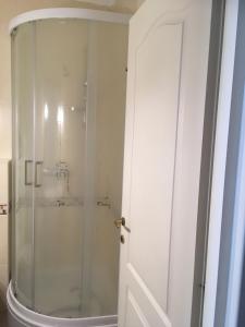 a shower with a glass door in a bathroom at Gruber Apartman in Siófok +53 photos