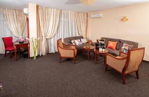 a living room with a couch and chairs and a table at Hotel Princess Residence in Kiten