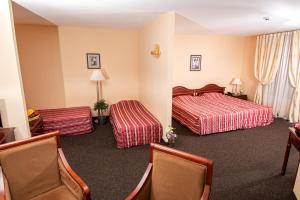 a hotel room with two beds and two chairs at Hotel Princess Residence in Kiten