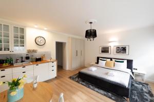a bedroom with a bed and a kitchen and a table at Balans Studio Old Town in Gdańsk