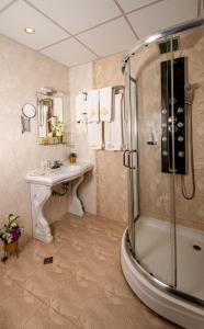 a bathroom with a shower and a sink and a tub at Hotel Princess Residence in Kiten +33 photos