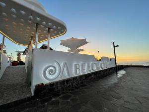 a sign for a black ash restaurant on the beach at Europe Villa Cortes GL in Playa de las Americas