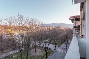 a view of a city from the balcony of a building at Industrial 2-BDR Flat by the National Stadium in Sofia