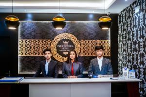 a group of three people sitting at a table at HOTEL PARK VICTORIA in Kolkata