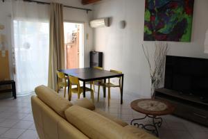 a living room with a couch and a table at Residence Enzo Paradise in La Seyne-sur-Mer