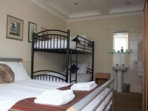 a bedroom with a bunk bed with towels on it at Seagull Hotel in Blackpool