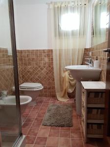 a bathroom with a toilet and a sink and a shower at sweet home la maddalena in La Maddalena