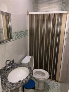 a bathroom with a sink and a toilet and a shower at Hotel Graciosa Palace in Palmas