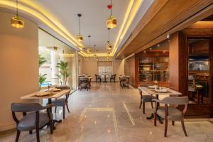 a restaurant with tables and chairs in a room at Maran Residence in Cairo