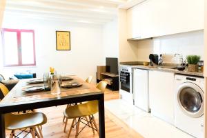a kitchen and living room with a table and a dishwasher at Porto Wine Loft Duplex with swimming pool in Vila Nova de Gaia