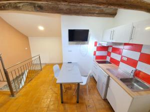 a small kitchen with a table and a sink at APPARTEMENT AGATHOIS-3 in Agde