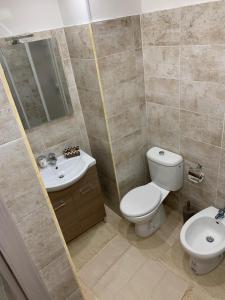 a bathroom with a toilet and a sink at The house Porta Garibaldi in Catania +10 photos