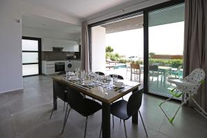 a dining room with a table with wine glasses on it at Villa Yria in Coral Bay