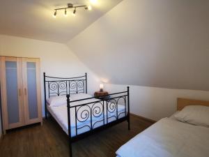 a bedroom with two beds and a lamp on a table at Stadtdomizil in Augsburg