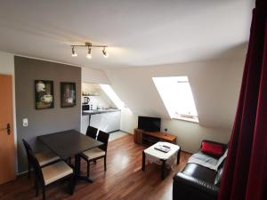 a living room with a table and a couch at Stadtdomizil in Augsburg +15 photos