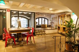 a room with a table and chairs and a piano at Eco Boutique Hostal Grau in Barcelona