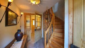 a hallway with a staircase and a vase on a table at Kienberghäusle in Pfronten