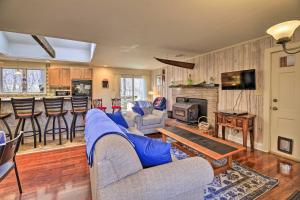 a living room with a blue couch and a fireplace at Pet-Friendly Cabin with Dock on Claytor Lake! in Radford