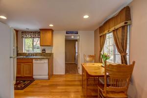 a kitchen with a wooden table and a dining room at Quiet Cabin in the Pines by Dwtn Prescott! in Prescott