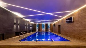 a swimming pool with blue lights in a building at Park House in Kryvyi Rih