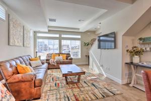 a living room with a couch and a table at Modern Aurora Getaway 22 Mi to Downtown Denver in Watkins