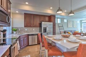 a kitchen with a large white table with chairs in it at Modern Aurora Getaway 22 Mi to Downtown Denver in Watkins
