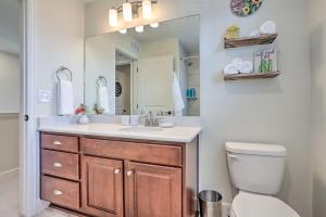a bathroom with a sink and a toilet and a mirror at Modern Aurora Getaway 22 Mi to Downtown Denver in Watkins +16 photos