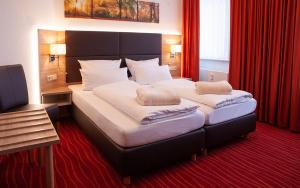 Postel nebo postele na pokoji v ubytování Hotel Meyer