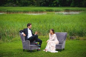 a bride and groom sitting on chairs in a field at Midlands Park Hotel in Portlaoise