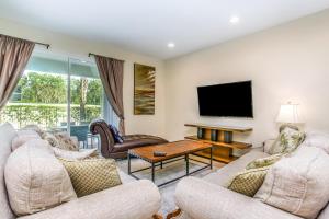 a living room with two couches and a flat screen tv at Encore Resort 8 Bedroom Vacation Home with Pool 2105 in Orlando