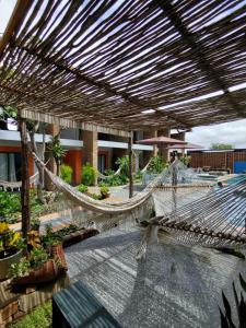 a hammock in the middle of a patio at JasmiManga Pousada in Caruaru