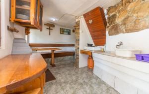 a kitchen with a sink and a cross on the wall at House Tvrdica in Tkon +15 photos