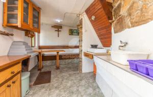 una pequeña cocina con fregadero y una cruz en la pared en House Tvrdica en Tkon