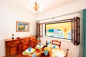 a dining room with a table and a window at Villa Ushuaia by Algarve Vacation in Guia