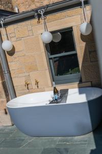 a white table in front of a brick building at Garden Rooms Edinburgh in Edinburgh