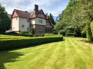 a large house with a large grass yard at Rossal House Apartments, Inverness, Highlands in Inverness