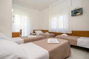 En eller flere senge i et værelse på Hotel Cà Vanni