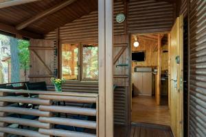 a room with a table and chairs on a house at Domki Letniskowe Kaprys in Pobierowo