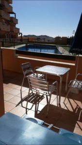 a patio with a table and chairs on a balcony at Torrox Costa in Málaga